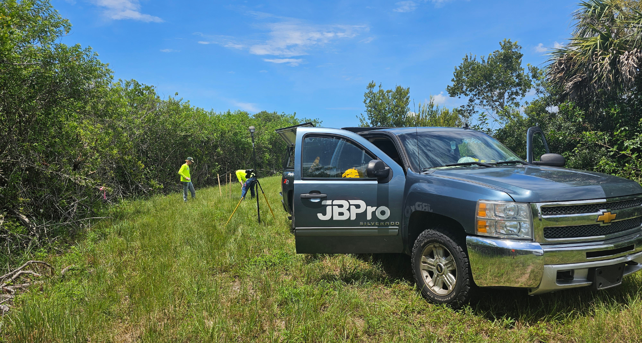 JBPro surveying crew and truck in the green path of Merritt Island Wildlife Refuge