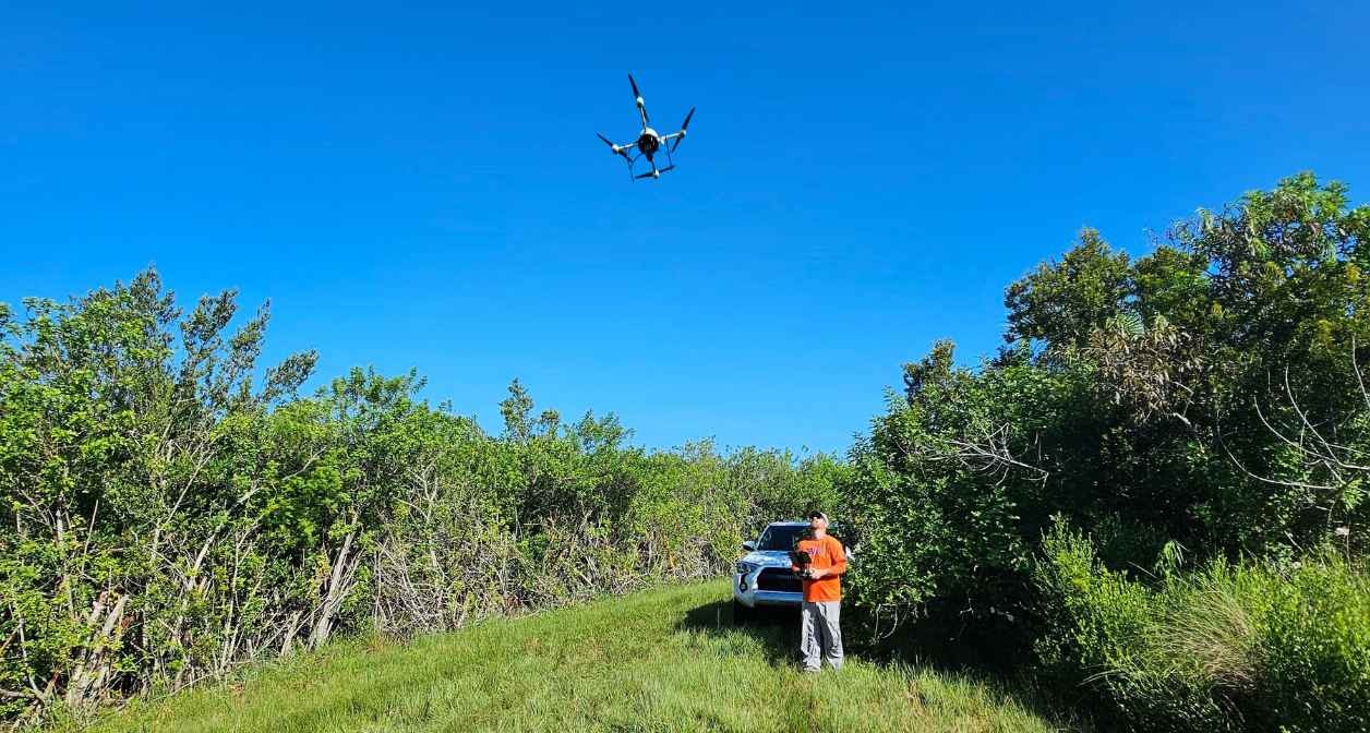 JBPro surveying crew member flying a surveying drone above the Merritt Island Wildlife Refuge